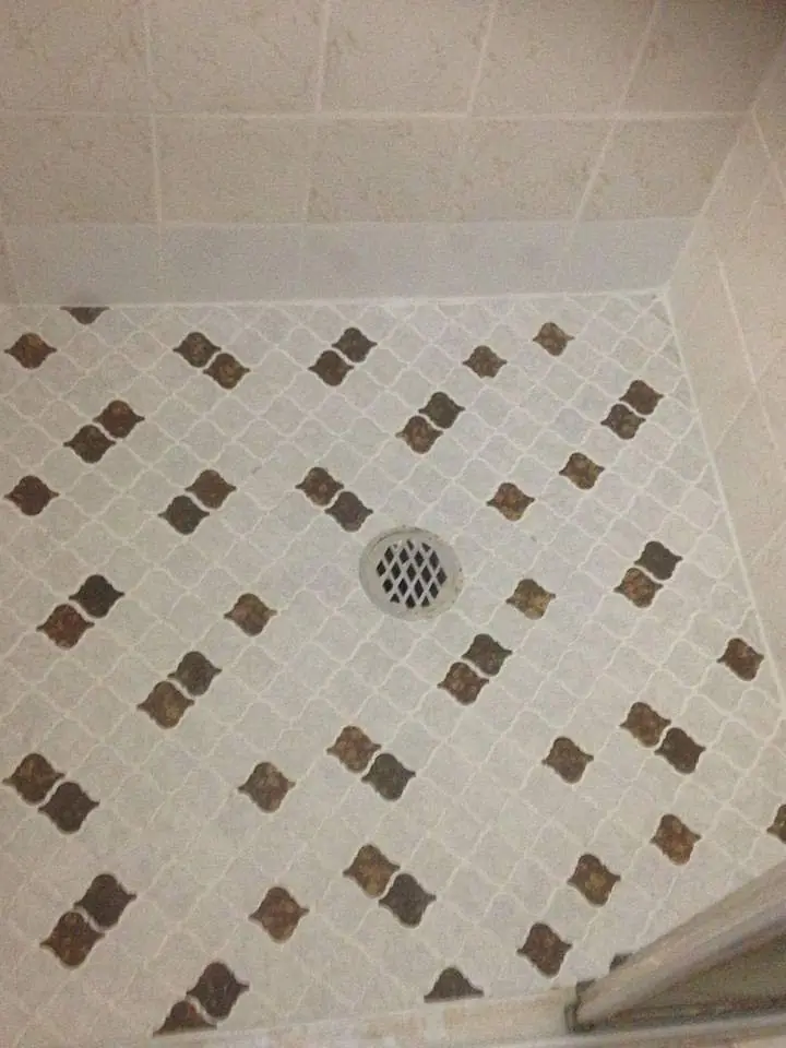 After: The same shower with clean floor grout and walls