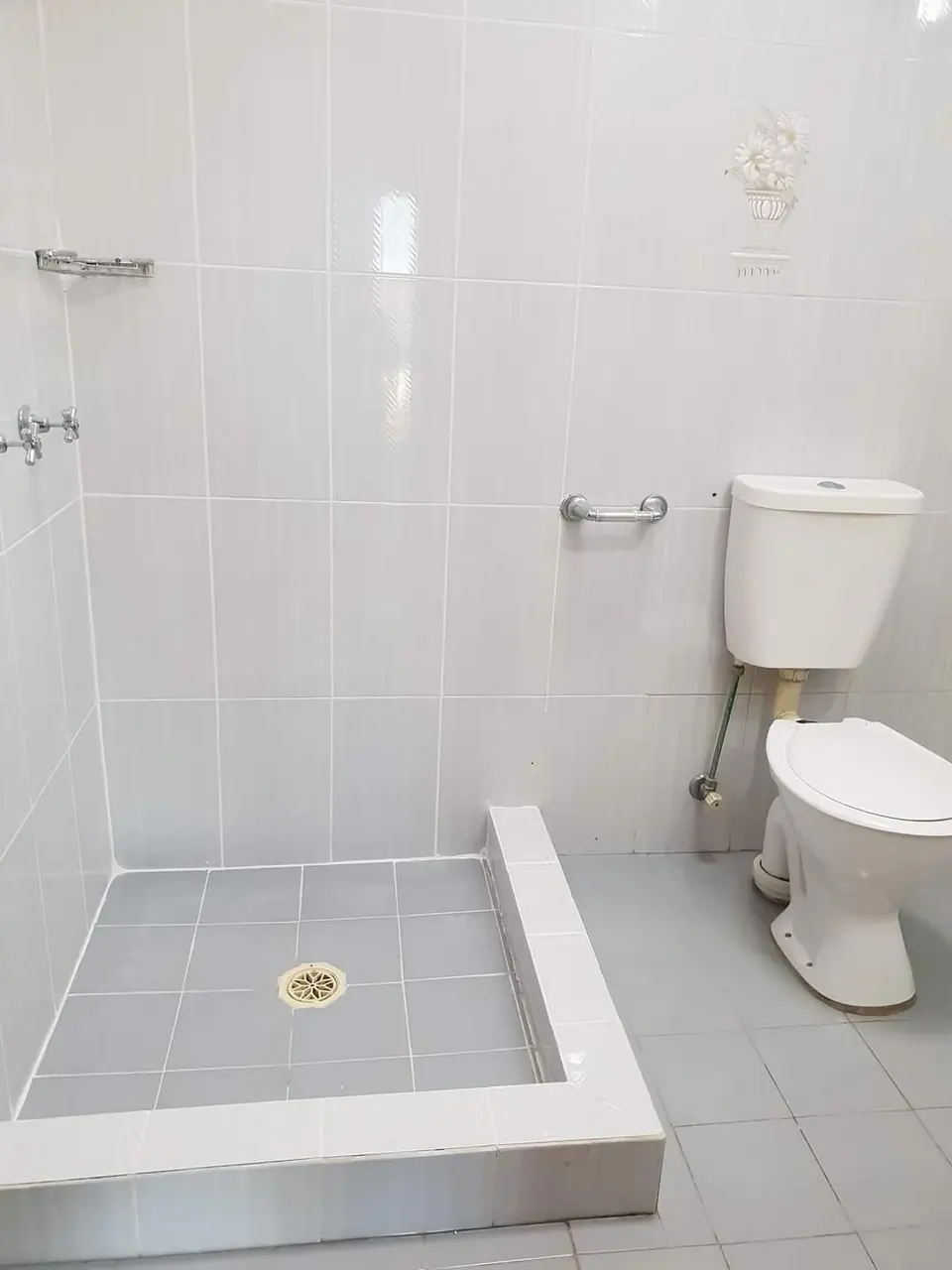 After: The same shower with the hob and base tiling restored and clean joints
